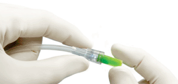 Image: Curos Tips protecting the male luer connector (Photo courtesy of Ivera Medical).